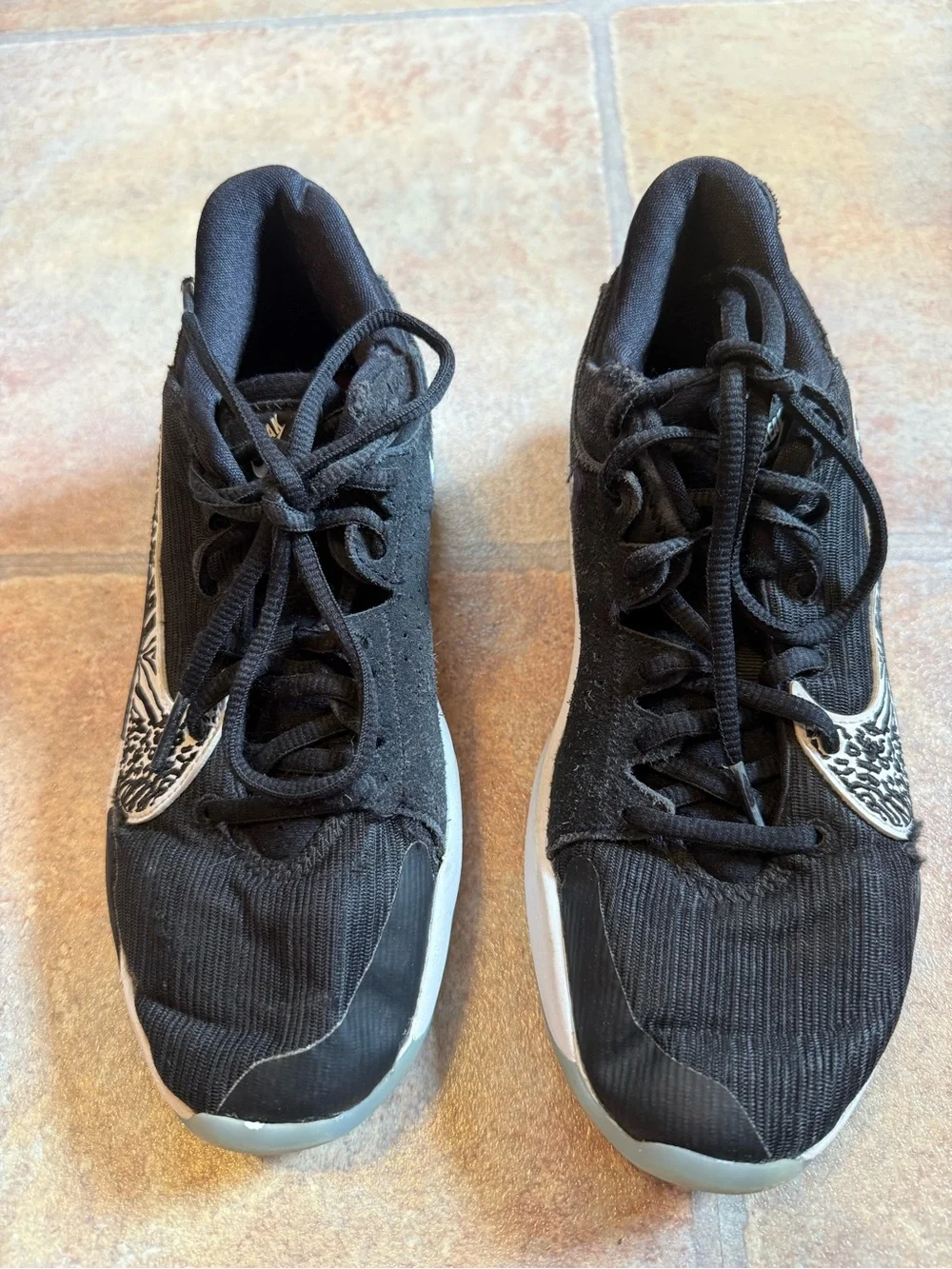 Nike Kids Black Sneakers with White Zebra Swoosh and Orange Logo